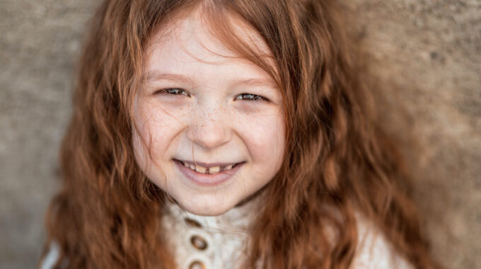 Portrait of a cute, little, girl in white dress